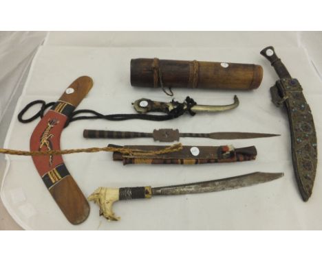 A kukri in a decorative leather case, other assorted daggers, spear/blow pipe and a quiver of arrows, etc