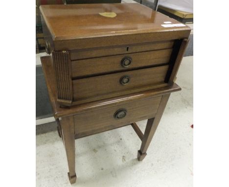 A mahogany canteen by Walker & Hall Ltd., Sheffield, on stand with stretchered base, containing cutlery by Walker & Hall, Fra