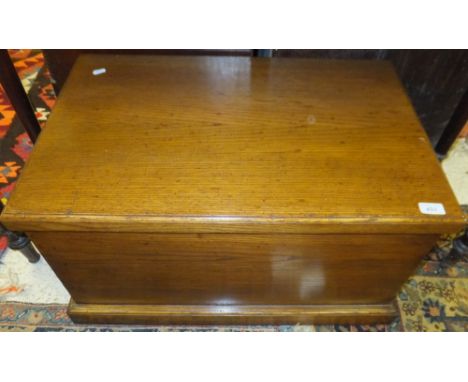 An oak trunk of plain form, raised on a plinth base