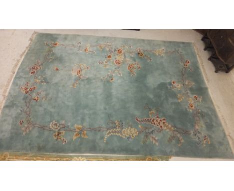 A Chinese carpet, the eau de nil ground decorated with basket and trailing flowers and foliage, 495 x 335cm, together with a 