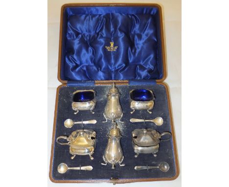 A cased silver condiment set to include two peppers, two open salts and two lidded mustards, together with four spoons