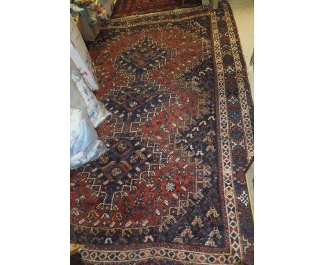 A Caucasian rug with repeating elephant foot medallions on a dark blue ground, 195 cm x 128 cm, together with a Caucasian car