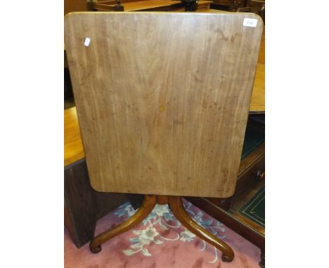 An early 19th Century mahogany tea table, the rounded rectangular top on a turned and ringed  pedestal to scrollwork tripod b