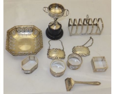 A George VI silver six section toast rack (by Emile Viner, Sheffield, 1938), a silver baby pusher, two silver bottle tags ins