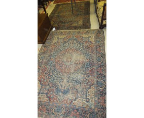 A pair of Tabriz rugs, the centre burgundy medallion within a blue floral decorated ground within blue, burgundy, terracotta 