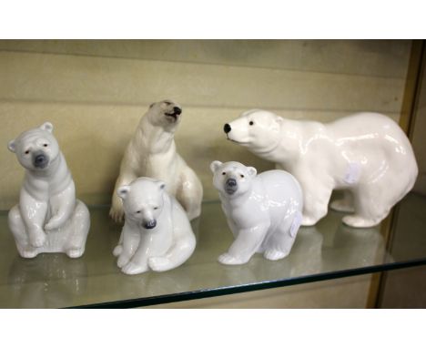 Three Lladro model polar bears, a Branscombe example and another (5)