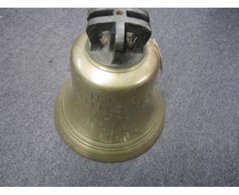 The Ship's bell from H.M.S. WHIMBREL 1942,a brass bell with H.M.S. Whimbrel 1942 engraved to one side and a Crow's foot engra