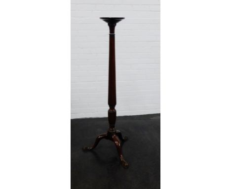 A mahogany torchere stand, with fluted column and tripod supports, 135cm