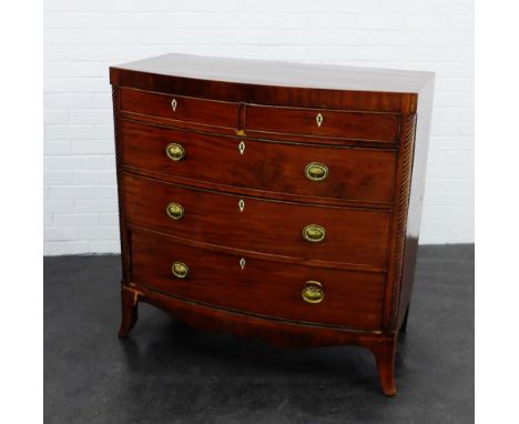 A 19th century mahogany bow fronted chest with two short drawers above three graduating long drawers, flanked by reeded pilas