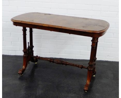 A Victorian walnut side table, on baluster  turned supports and stretcher with ceramic castors,  75 x 108cm