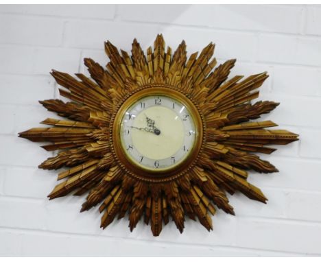 A vintage Smiths sunburst wall clock, 50 x 68cm