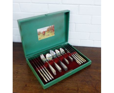 A Community Plate cutlery canteen contained within a green painted wooden box with hunting scene to top