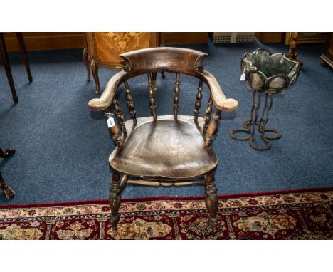 Oak Windsor Captain's Chair, bobbin turned.  Traditional style, saddle seat, turned stretchers.  Measures 19'' wide x 20'' de