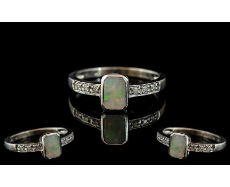 Ladies 9ct Gold - Attractive Opal and Diamond Set Ring. Fully Hallmarked for 9.375. The Central Opal Flanked by 6 Diamonds to