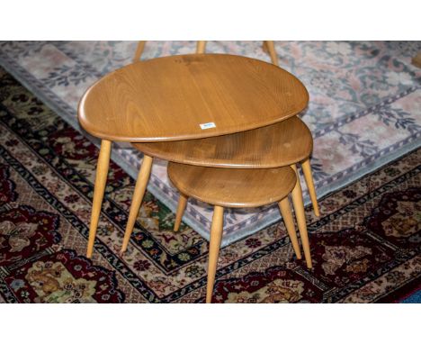 An Ercol Blonde Beech Nest Of Three Pebble/Elm Tables Largest Table 25 x 17 inches, height 16 inches. 