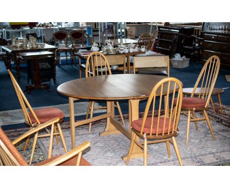 An Ercol Blonde Beech/Elm Dining Table and Four Chairs Circular Drop Leaf Dining Table With Four Spindle Back Chairs. Table T