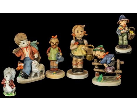 Four Goebel Hummel Figures,  comprising a boy with a basket of chicks, girl with watering can, a boy climbing a stile, and a 