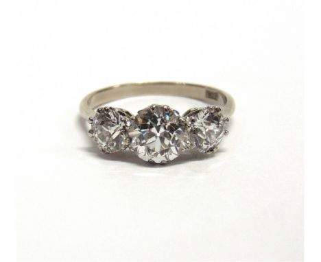 A THREE STONE DIAMOND RING the white mount stamped '18ct', the graduated old cuts calculated as weighing approximately 0.45 c