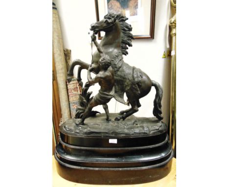 A LARGE BRONZED SPELTER MODEL OF THE HORSE AND TRAINER OR 'MARLEY' AFTER GUILLAUME COUSTOU  19th century, mounted on a heavy 