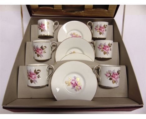 AN AYNSLEY CASED COFFEE SERVICE  comprising six saucers and six coffee cans, with floral and gilt decoration
