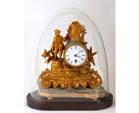 A CONTINENTAL GILT METAL FIGURAL MANTLE CLOCK  the enamel dial with Roman numerals, 34cm wide 40cm high overall