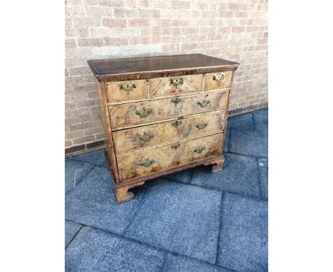 AN 18TH CENTURY WALNUT CHEST OF THREE SHORT AND THREE LONG DRAWERS  with featherbanded decoration on shaped bracket feet, 102