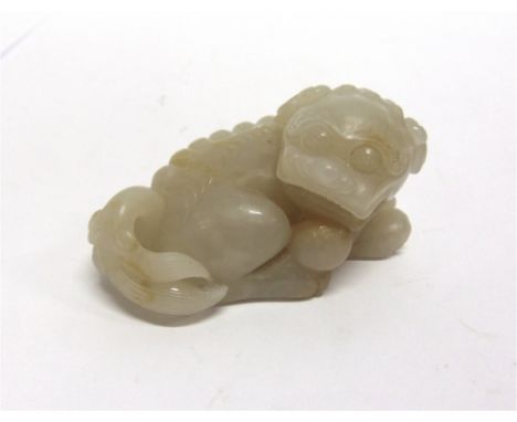 A CHINESE CARVED JADE FIGURE OF DOG OF FO  in recumbent pose, 7.5cm long