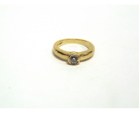 A SINGLE STONE DIAMOND 18 CARAT GOLD RING the rub over set brilliant cut of approximately 0.2 carats, finger size G, 4.3g gro