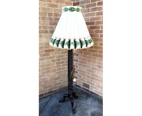 A MAHOGANY STANDARD LAMP  on tripod base, with shade