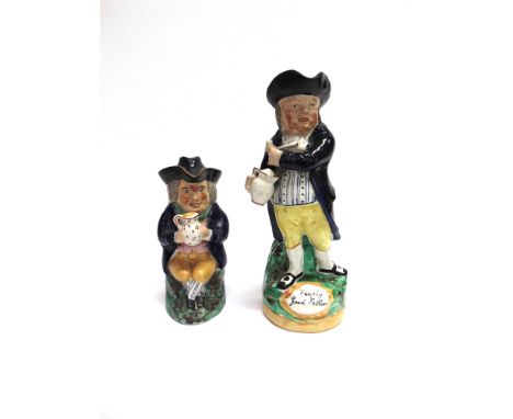 A PAINTED STAFFORDSHIRE CHARACTER JUG the figure in 18th century style dress holding a pipe, the naturalistic base inscribed 