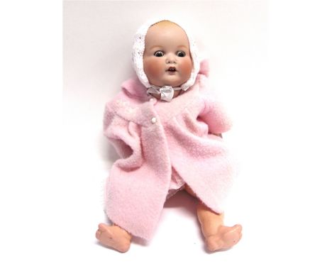 AN ARMAND MARSEILLE BISQUE SOCKET HEAD DOLL  with moulded and spray-painted hair, sleeping brown glass eyes, and an open mout