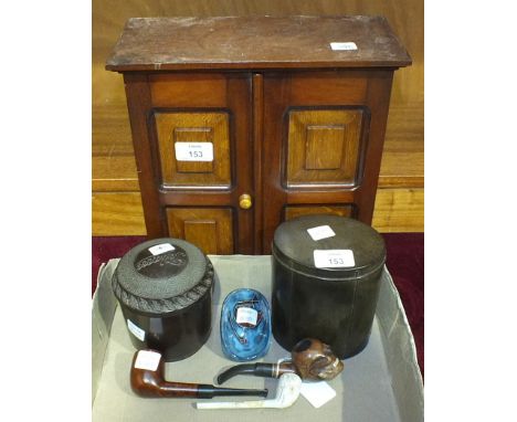 A mahogany two-door smoker's cabinet, 28cm wide, 30cm high, a Bakelite tobacco jar and cover, one other, a wooden pipe, the b