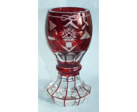 A Bohemian cut and engraved Masonic firing glass beaker in clear glass overlaid with ruby, cut and engraved with Masonic symb