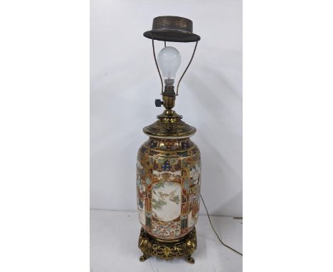 A Japanese Meiji Satsuma table lamp decorated with panels of birds and figures, gilt mounts with elephant formed feet, 40.5cm