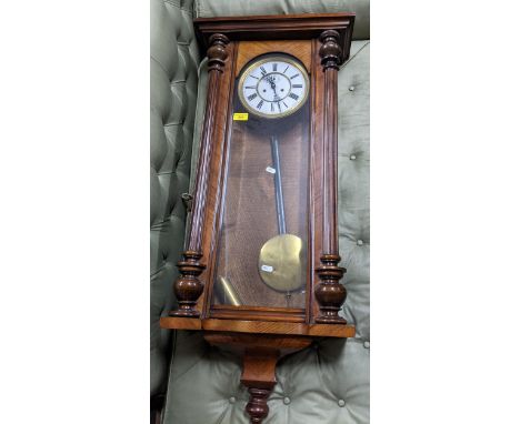 A 20th century mahogany cased Vienna style regulator wall clock, white enamel dial with Roman numerals, single weight, pendul