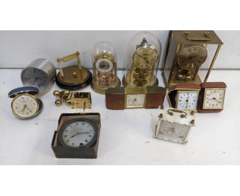 A group of clocks to include a mid 20th century Smiths alarm clock, a Haller carriage clock, an eight day movement boxed cloc