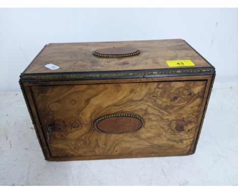 A Victorian walnut cigar /pipe box, the swivel front with fitted interior and lock with key, the front an top with applied ov