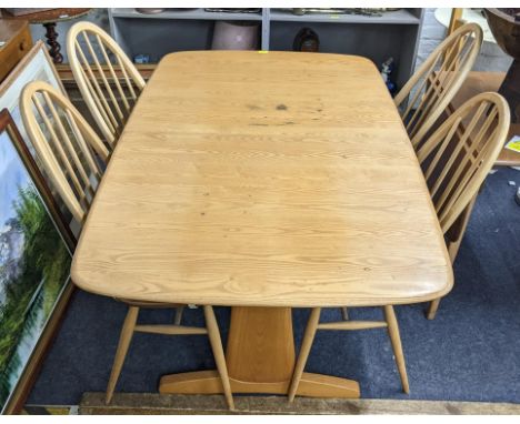 A mid 20th century Ercol blonde elm trestle dining table, 72.5cm x 152cm w and a set of four hoop spindle back chairsLocation