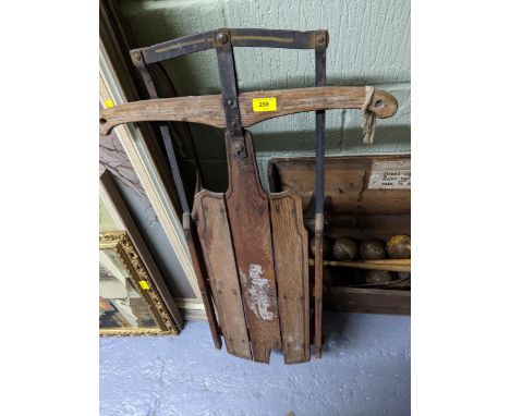 A vintage wooden American sledge by S L Allen of Philadelphia, model Flexible Flyer No 1 E with metal runners A/F, along with