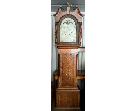 A George III oak cased 8 day longcase clock having a broken swan neck pediment, arched dial and striking on a bell, 233h x 57