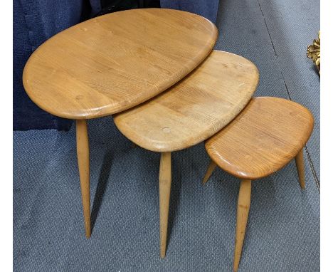 A mid 20th century Ercol blond elm and beech nest of three pebble tables, the largest 40.5cm h x 65cm wLocation:If there is n