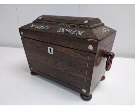 A 19th century mother of pearl inlaid rosewood tea caddy of sarcophagus form, with ring handles and a twin compartmented lidd