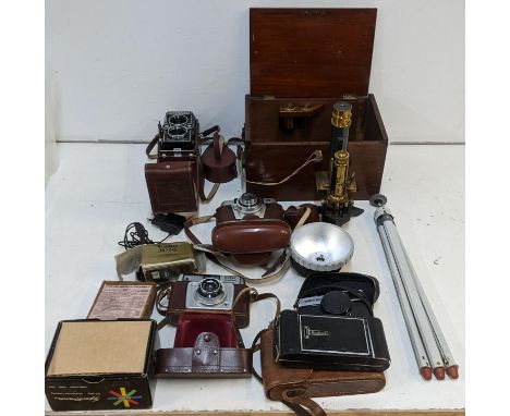 A mixed lot of mostly photography equipment to include a vintage Rollei Magic, an Olympus Trip 35, a boxed vintage microscope