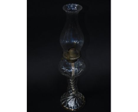 A Victorian moulded spiral fluted oil lamp, with glass chimney, 43cm H.