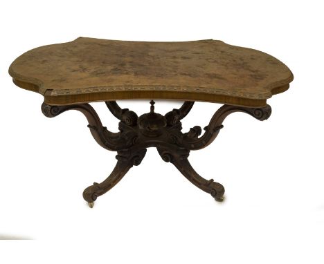 A Victorian walnut centre table, with moulded serpentine top, on a four S scroll supported basket base, with blind and matted