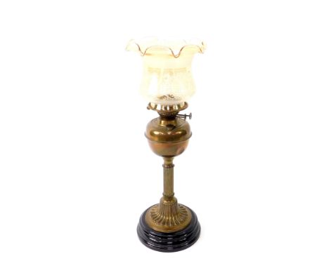 A Duplex brass oil lamp, with a fluted column raised on a black socle base, with chimney and etched amber glass shade, 67.5cm