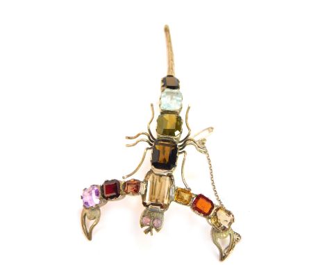 A scorpion brooch, set with semi precious stones in white metal, with safety chain as fitted, 11cm H.