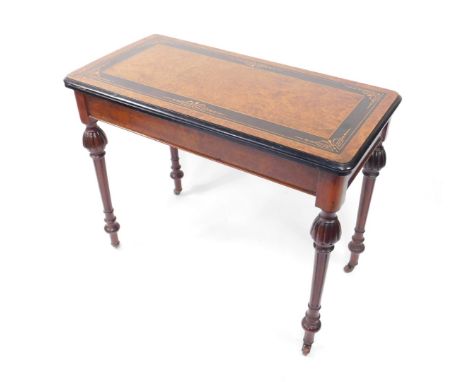 A Victorian birds eye maple and ebony foldover card table, with boxwood inlay, raised on turned and fluted legs, brass capped