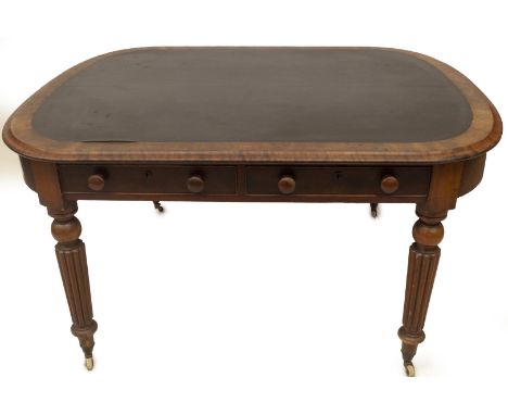 A George IV mahogany library table, with a rounded rectangular top with green leather centre and moulded edge, two opposing f