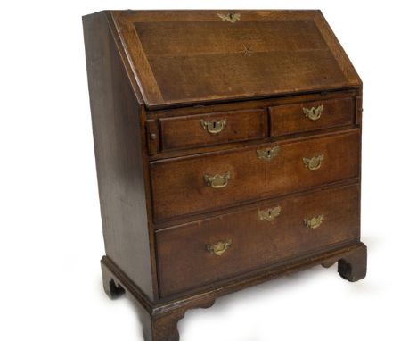 A George II oak bureau, with crossbanded fall flap, with parquetry star resting on lopers, revealing fitted interior of shape